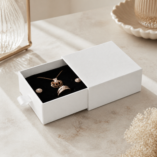 White mini drawer jewelry box presented in a boutique jewelry-store display scene.