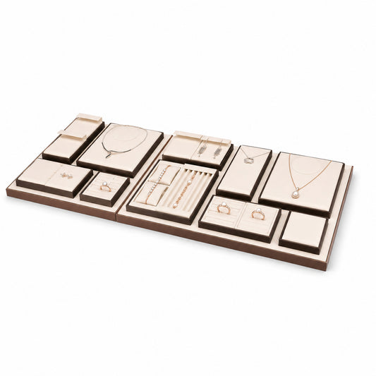Custom Cream Compartment Jewelry Display Tray Collection without the backboard, styled with necklaces, earrings, rings and bracelets across the coordinated display pieces