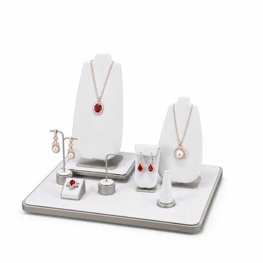 Custom White Geometric Countertop Jewelry Display without the backboard, styled with necklaces, earrings, rings and bracelets across the coordinated display pieces