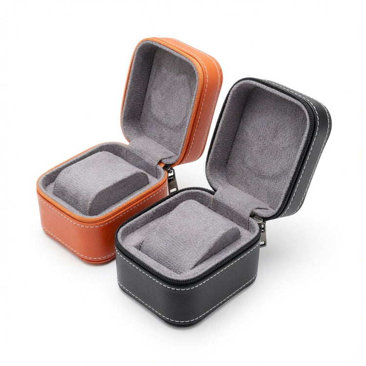 Open orange and black single watch boxes with gray cushioned interiors in the Jeweller Buy watch box collection.