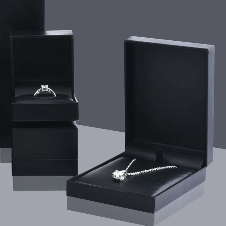 Assorted Lux PU jewelry boxes for rings, pendants, bracelets, and necklaces in multiple colors and rounded designs.