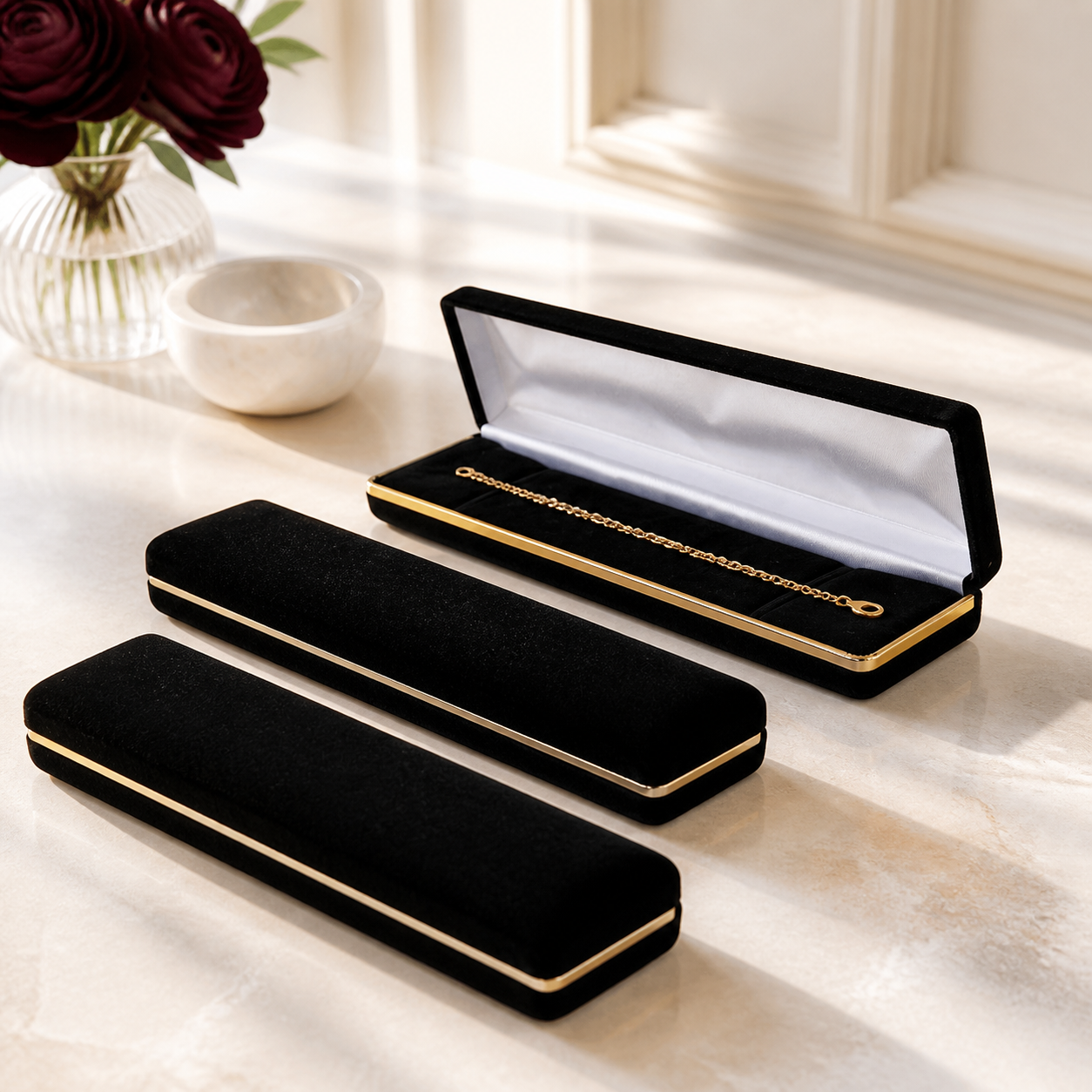 Bright black and gold bracelet boxes arranged in a luxury showroom