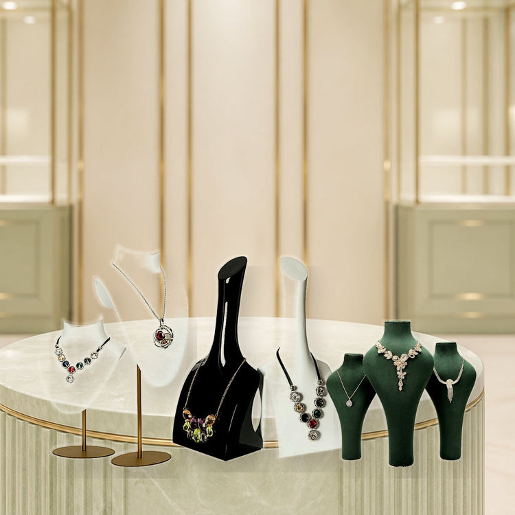 Custom necklace display busts with detailed materials in a bright luxury showroom