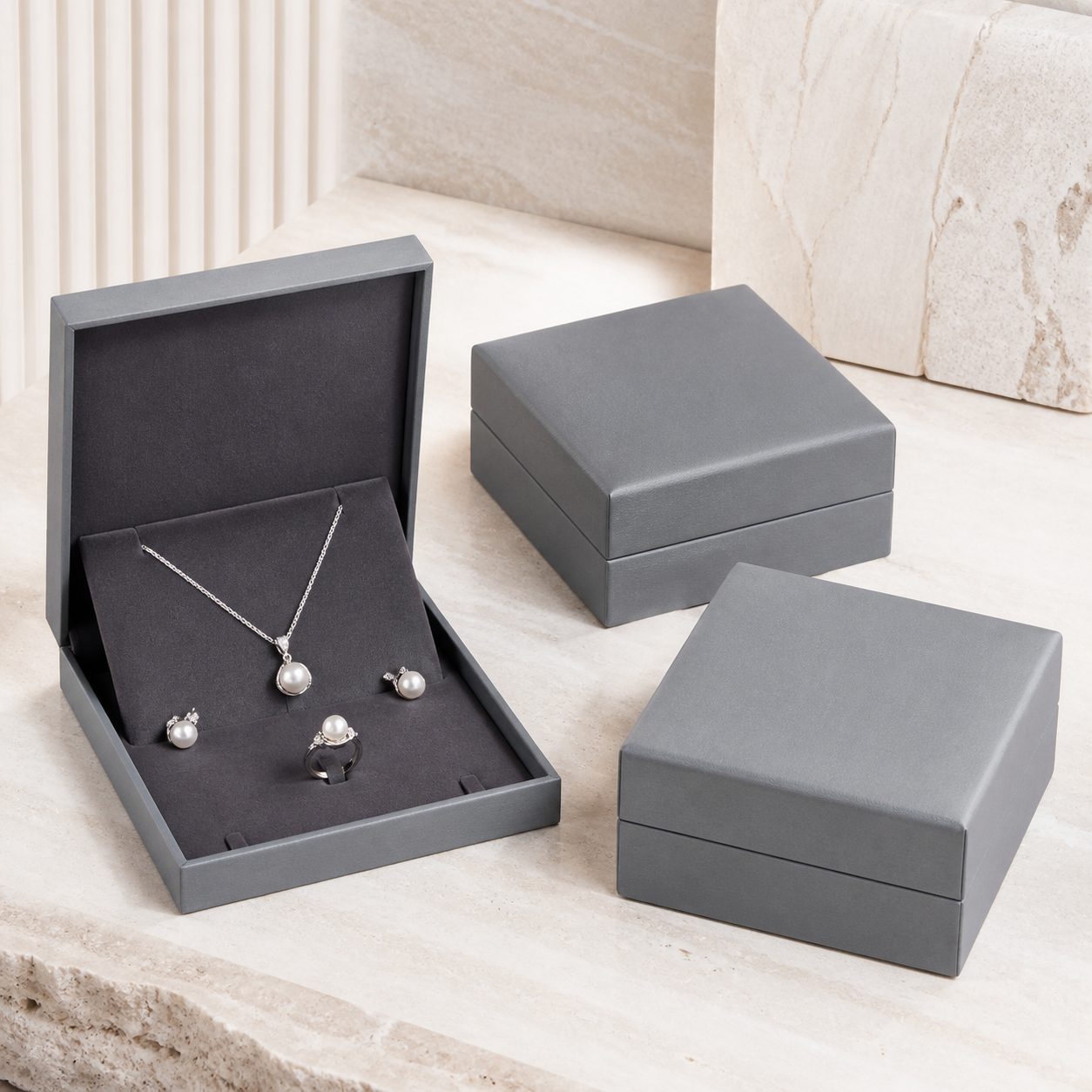 Bright gray jewelry set boxes displaying a coordinated pearl jewelry set