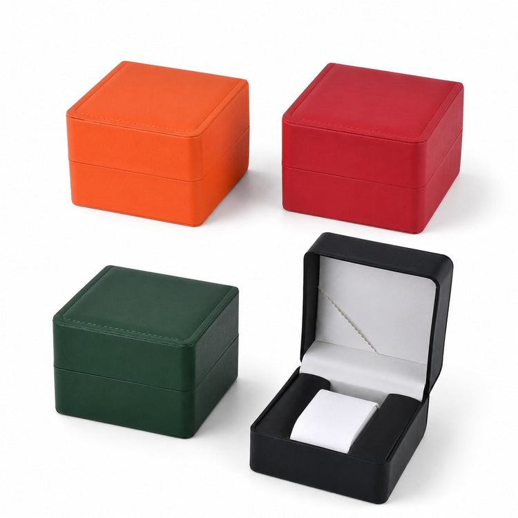 Multicolor watch boxes arranged in two parallel rows with orange, red, green, and open black styles for retail display and gift packaging.