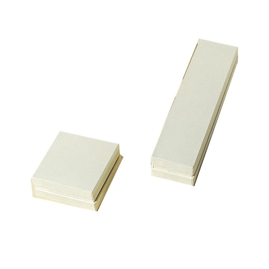 Four off-white custom lid-and-base jewelry box sizes on white