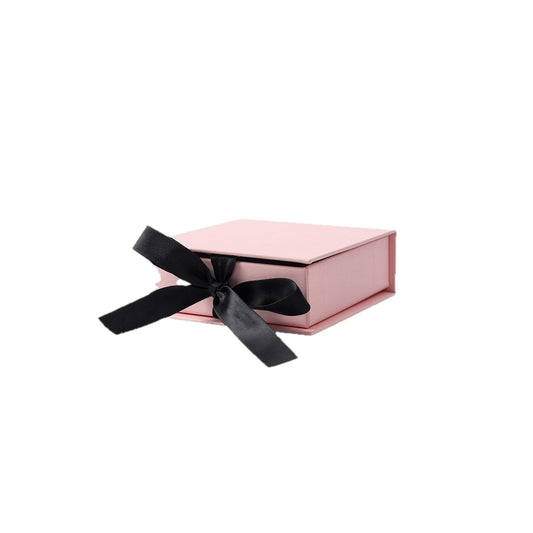 Pink ribbon-closure flip-top jewelry box on a pure white background