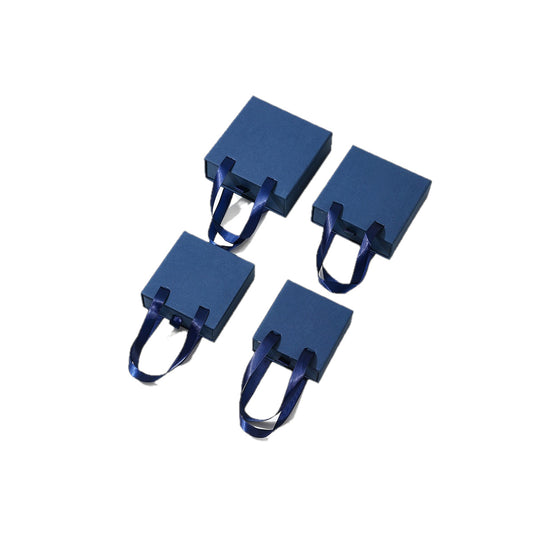 Navy blue handled drawer jewelry boxes on a pure white background