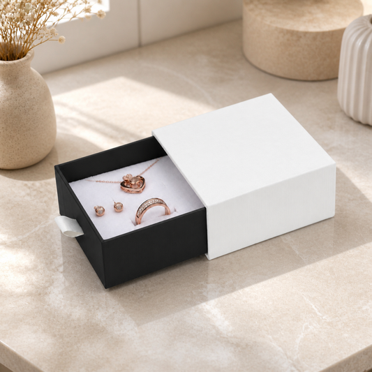 Black and white jewelry drawer box presented in a boutique jewelry-store display scene.