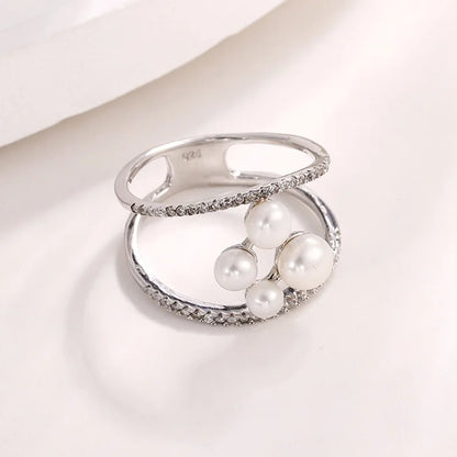 Minimalist simple irregular freshwater pearl engagement ring with diamonds around it