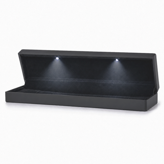 Open black bracelet box with two LED spotlights and a soft black padded interior