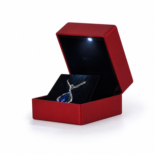 Open deep red earring box with a built-in LED light and black padded interior