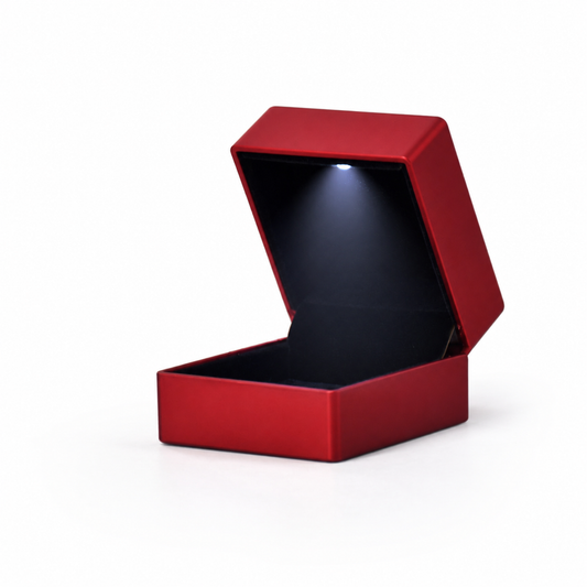Open red plastic LED ring box with cool-white light and black velvet interior