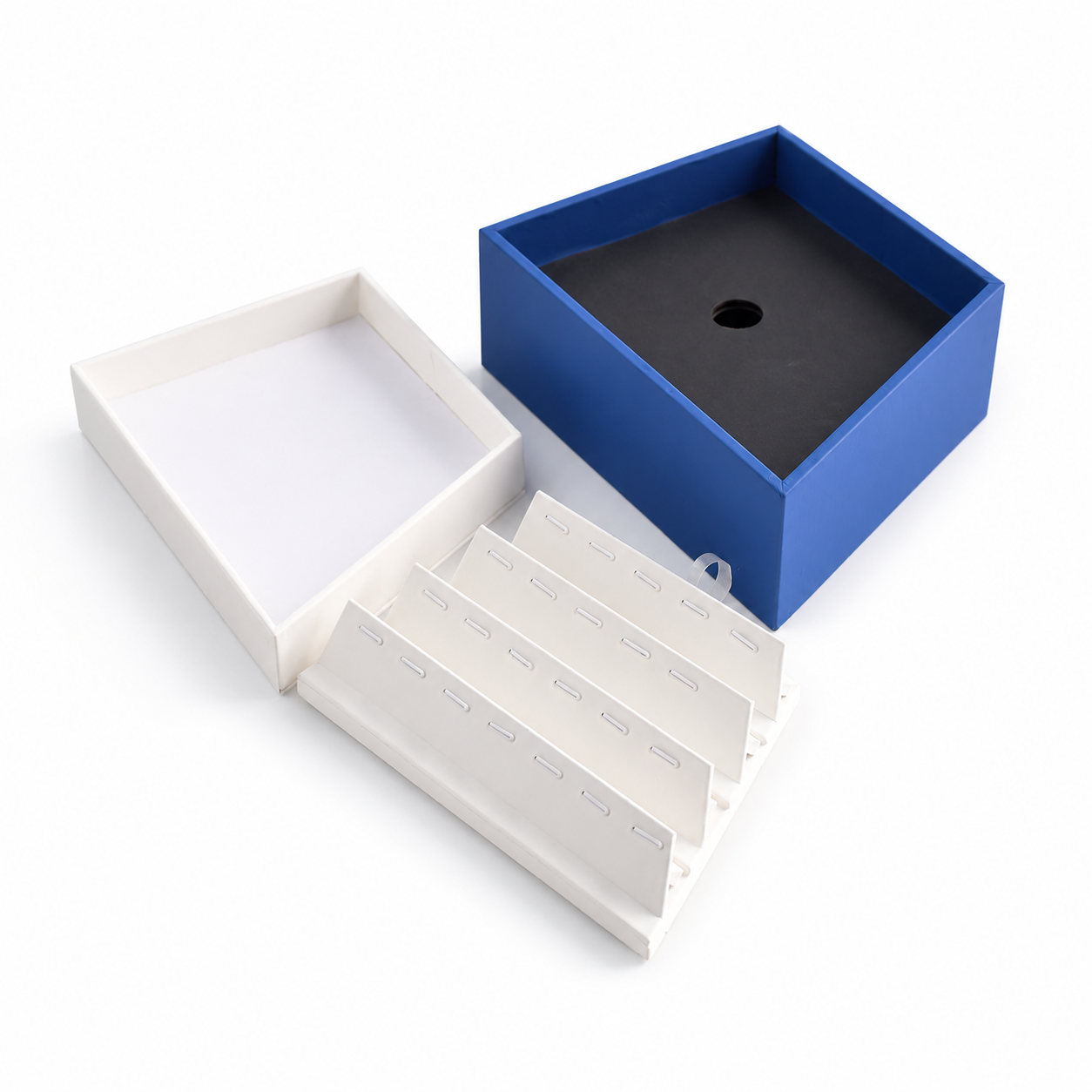 White four-row pendant organizer insert inside a blue jewelry tray