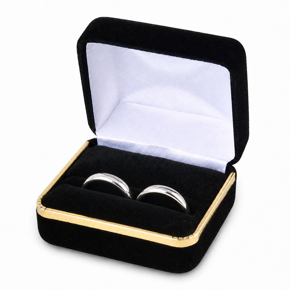 Black velvet double ring box with gold trim and two silver wedding bands seated side by side.