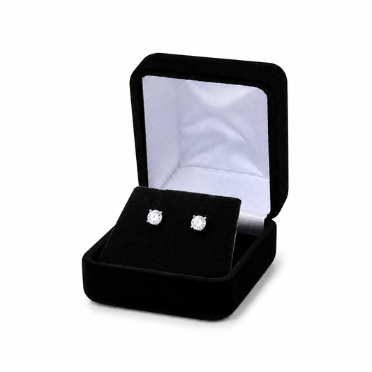 Black velvet earring box displaying two stud earrings
