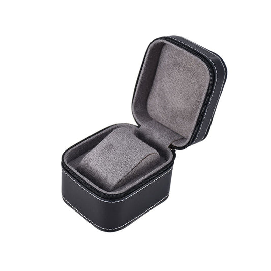 Open black single watch travel case with gray padded lining and a fitted cushion on a white background.
