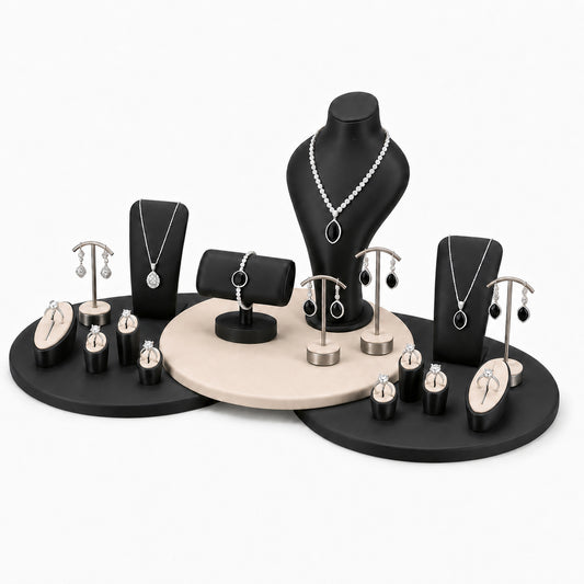 Custom Black Circular Platform Jewelry Display Rack Set without the backboard, styled with necklaces, earrings, rings and bracelets across the coordinated display pieces
