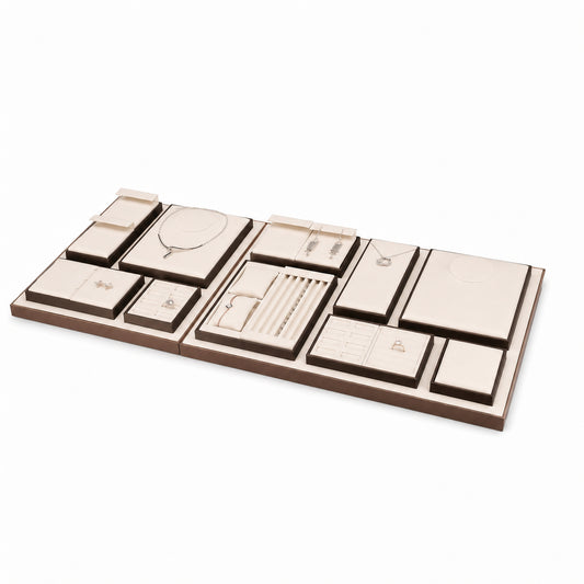 Custom Cream Compartment Jewelry Display Tray Collection shown without the backboard in a cream, brown and gold accents arrangement with jewelry visible on the display pieces