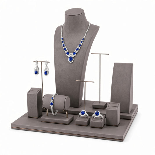 Custom Gray Coordinated Jewelry Retail Display Set without the backboard, styled with necklaces, earrings, rings and bracelets across the coordinated display pieces