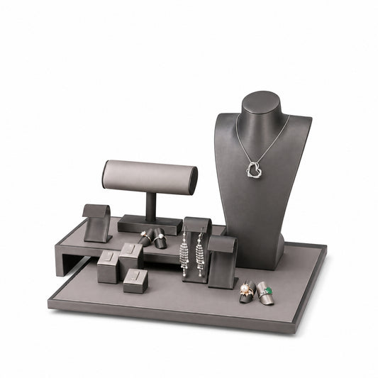 Custom Gray Elevated-Bridge Jewelry Display Props Set shown without the backboard in a gray and black arrangement with jewelry visible on the display pieces