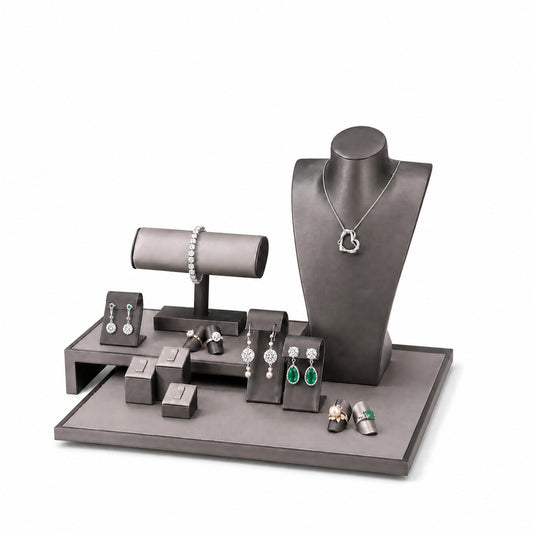 Custom Gray Elevated-Bridge Jewelry Display Props Set without the backboard, styled with necklaces, earrings, rings and bracelets across the coordinated display pieces