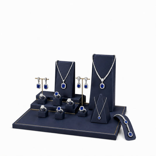 Custom Navy Tiered Jewelry Showcase Display Set without the backboard, styled with necklaces, earrings, rings and bracelets across the coordinated display pieces
