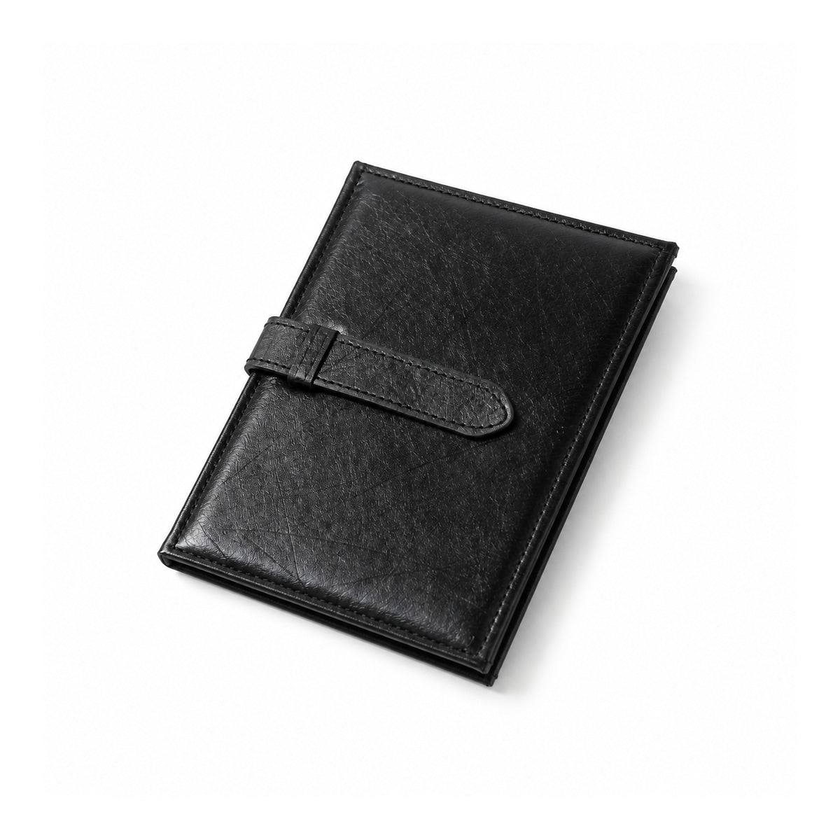 Black earring storage book, closed with stitched edges and strap fastening.