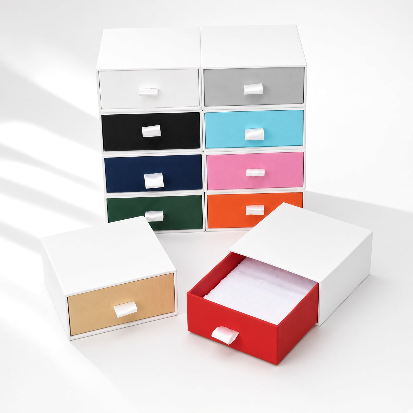 Black jewelry boxes drawers for rings, earrings, studs, pendants and compact necklaces — assorted-color collection scene.