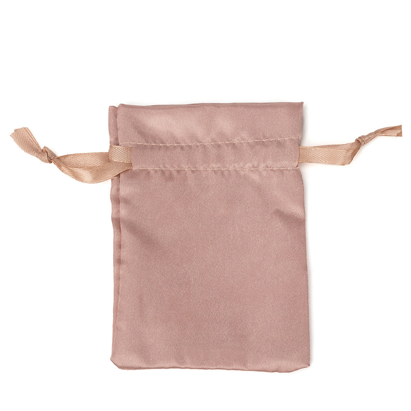 Champagne satin jewelry pouch with ribbon drawstrings on a white background