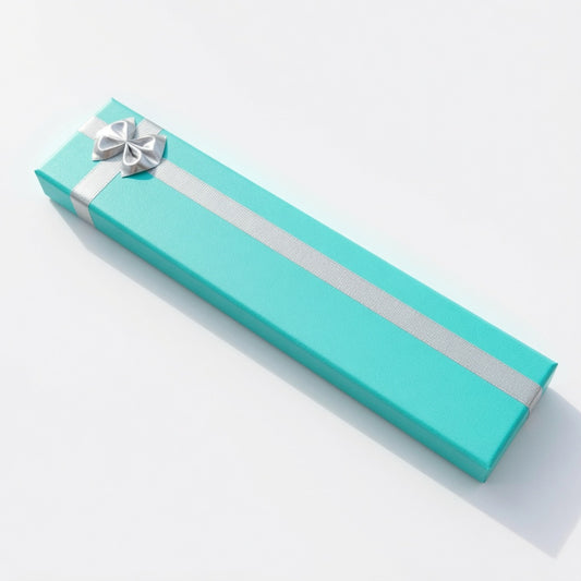 Closed lake blue paper bracelet box with silver ribbon and bow