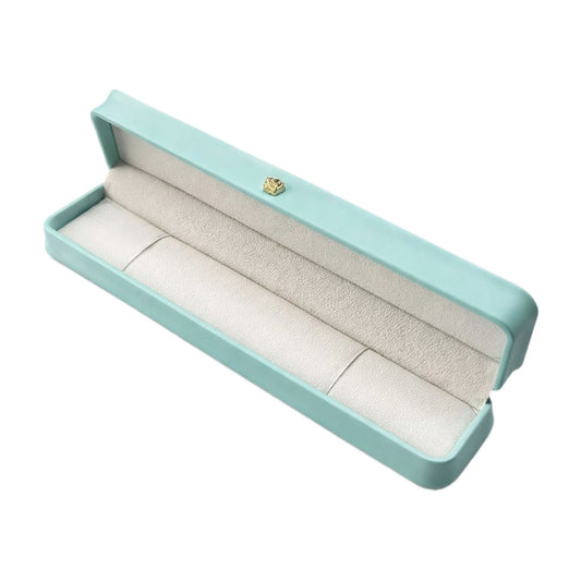 Open Tiffany Blue rounded bracelet box with an elongated padded interior and gold-tone lid ornament.