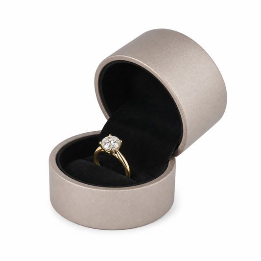 Open champagne PU ring box with round diamond engagement ring