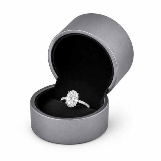 Open gray PU ring box with oval diamond engagement ring