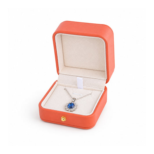 orange PU pendant box open in a three-quarter view with a pendant and chain.