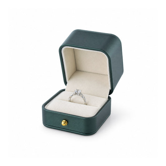 jade green PU ring box open in a three-quarter view with a diamond ring.