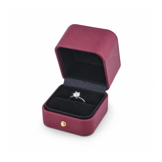 magenta PU ring box open in a three-quarter view with a diamond ring.