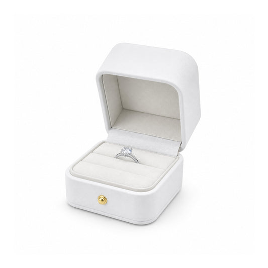 white PU ring box open in a three-quarter view with a diamond ring.